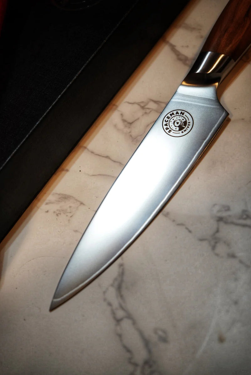 Chef's knife with a brand logo on a marble surface