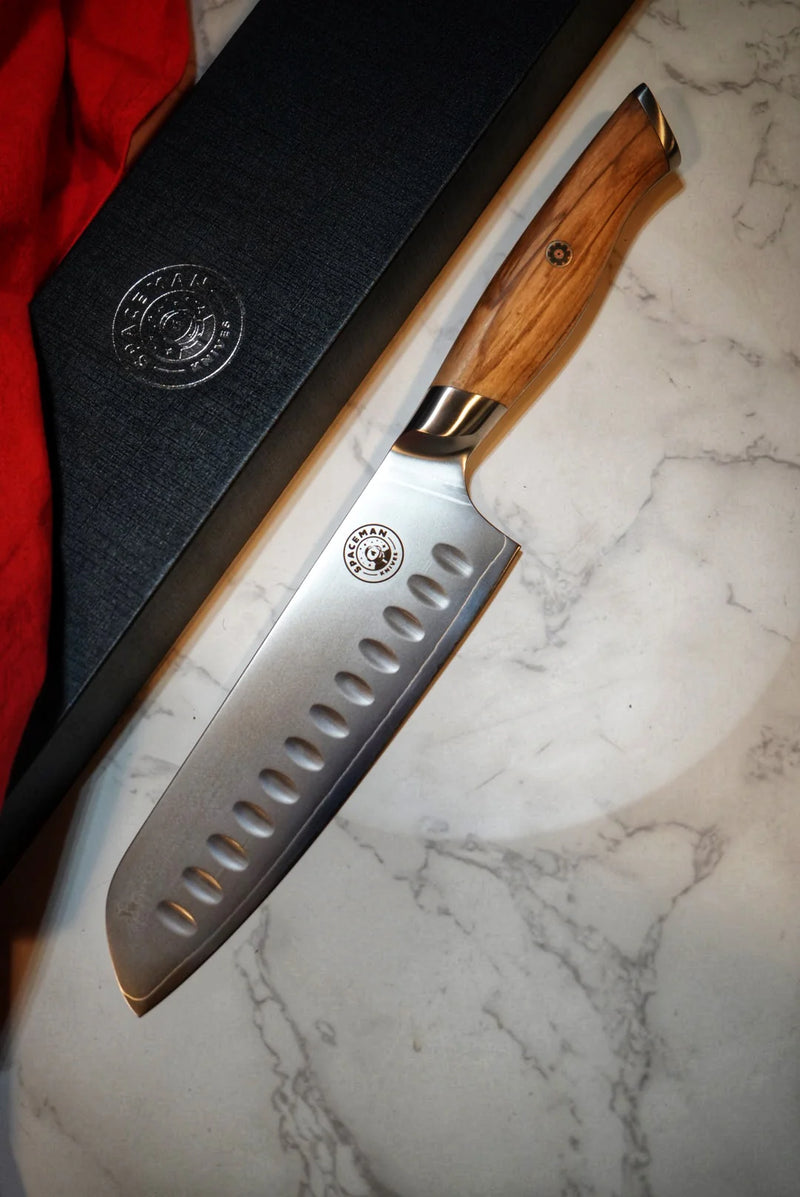 Chef's knife with wooden handle on a marble surface
