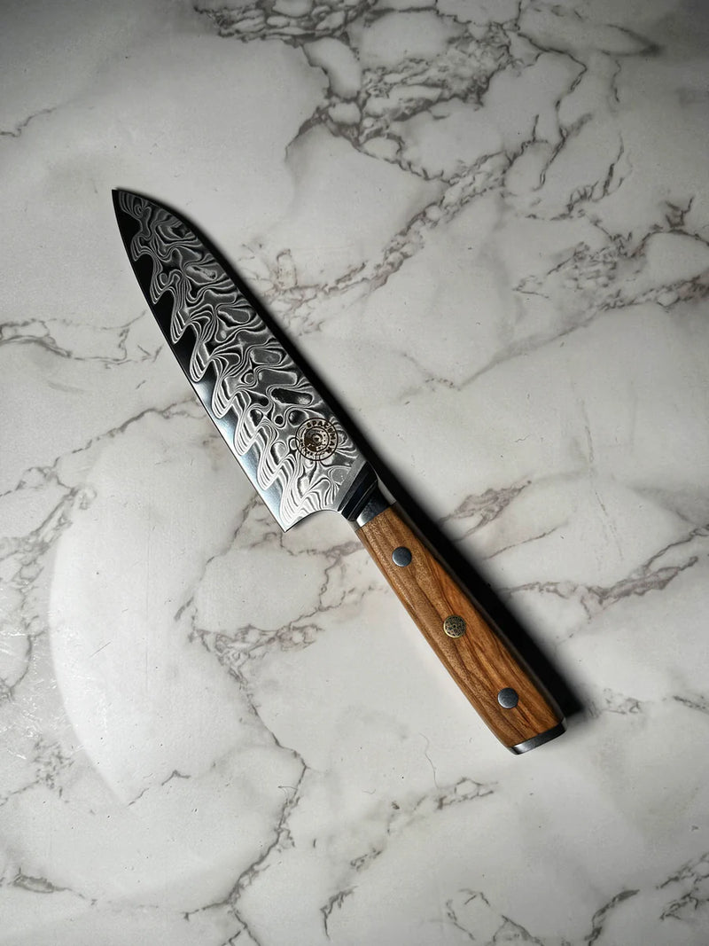 Decorative chef's knife with a wooden handle on a marble surface