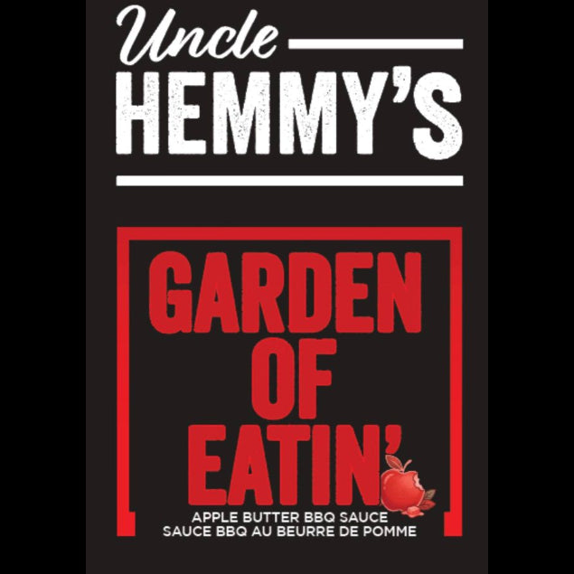 Front of a Uncle Hemmy's Garden of Eatin' apple butter BBQ sauce package, 500 mL. The design has a black background with white 'Uncle HEMMY'S' text at the top and bold red 'GARDEN OF EATIN'' text inside a red border.