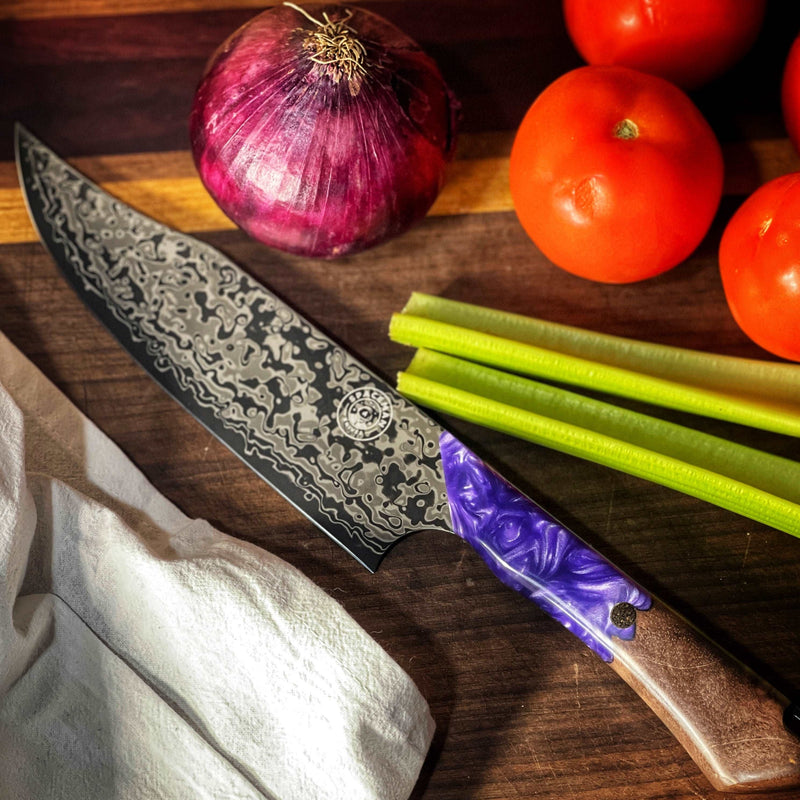 Black Chef knife with a purple and wooden handle on a cutting board with veggies