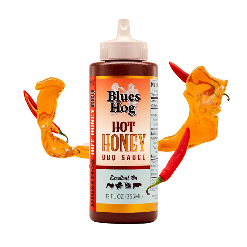 Blues Hog Hot Honey BBQ Sauce bottle with chili peppers on an orange background