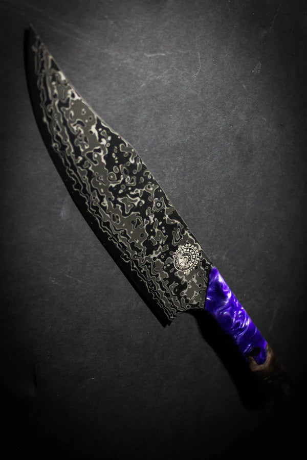 Decorative knife with a textured blade and purple handle on a dark background