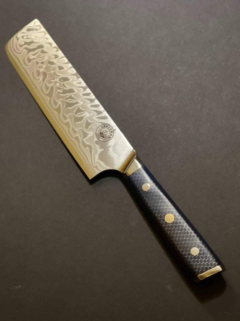 Decorative chef's knife with a textured handle on a dark background