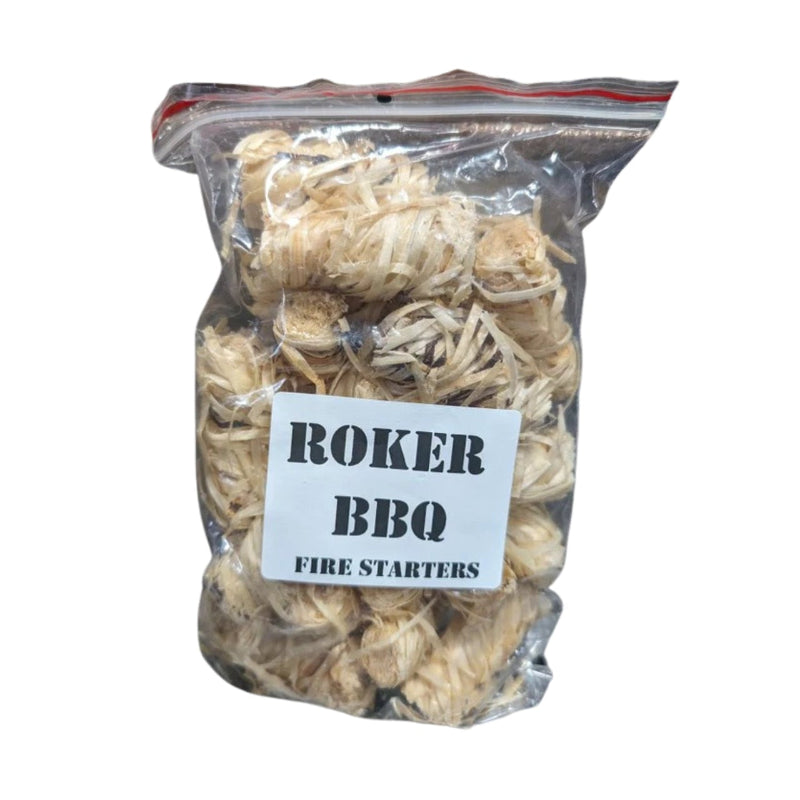 A clear plastic zip-top bag filled with shredded light tan fire starter material, with a white label reading 'ROKER BBQ FIRE STARTERS' on a plain white background.