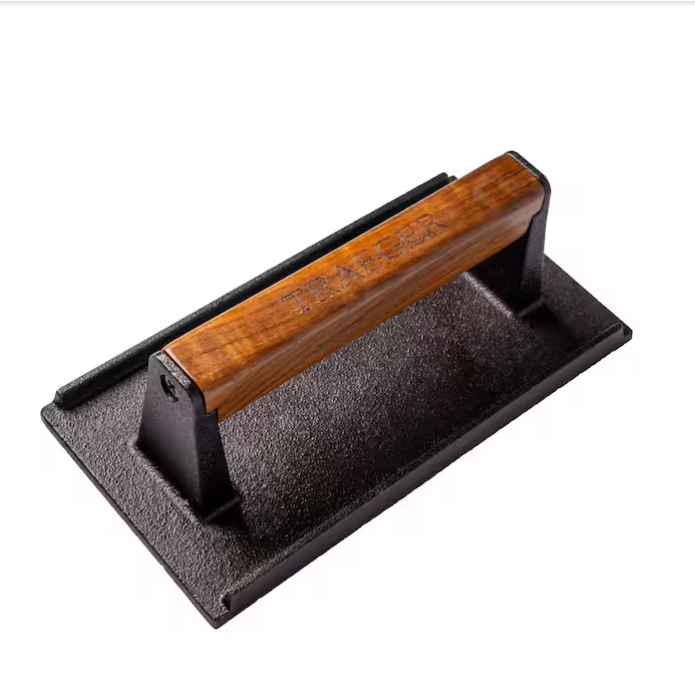 Cast iron burger press on a white background