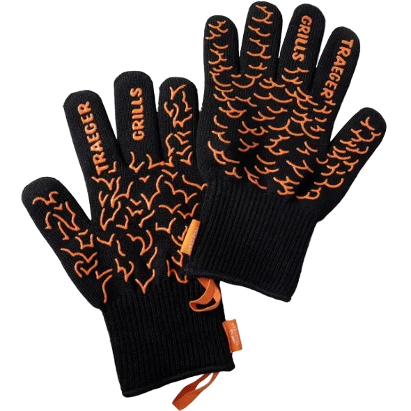 Black gloves with orange flame pattern and Traeger Grills branding on a white background