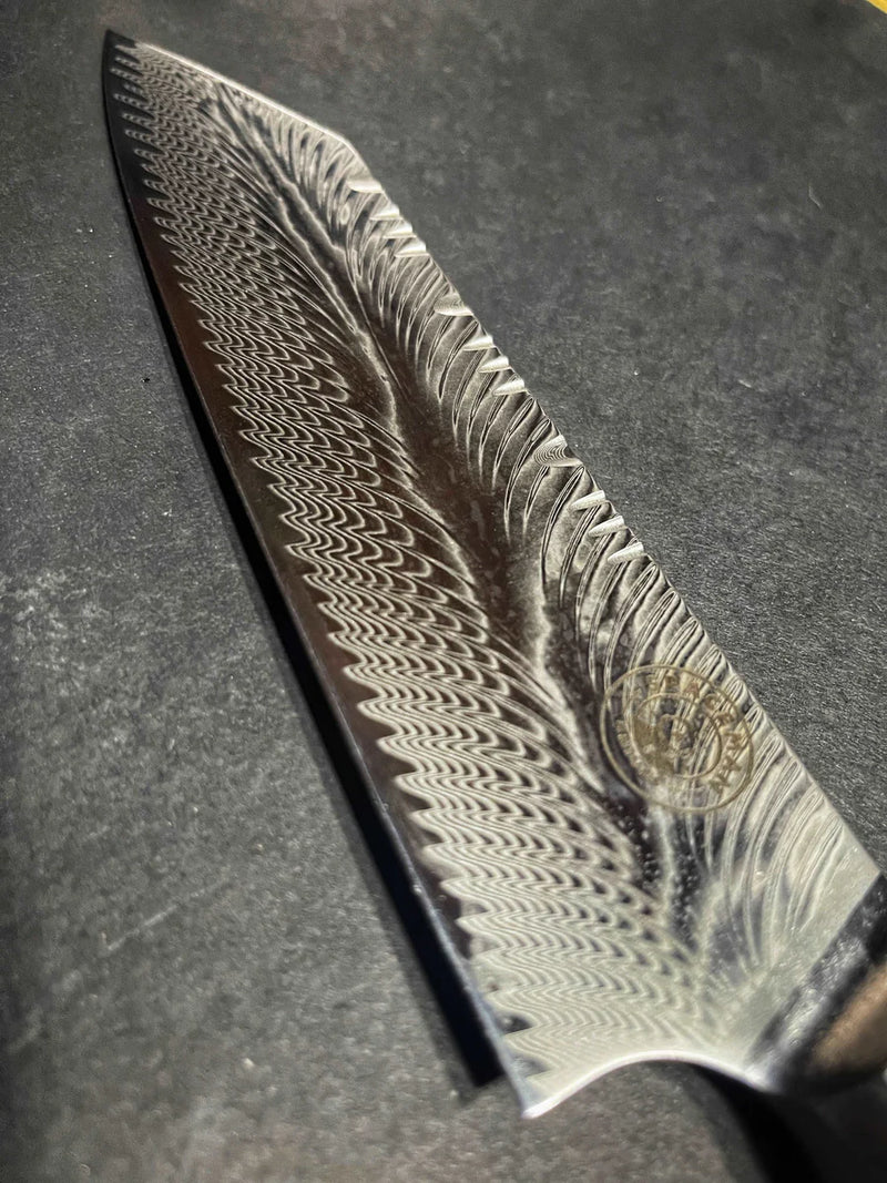 Close-up of a Damascus steel knife blade on a dark surface
