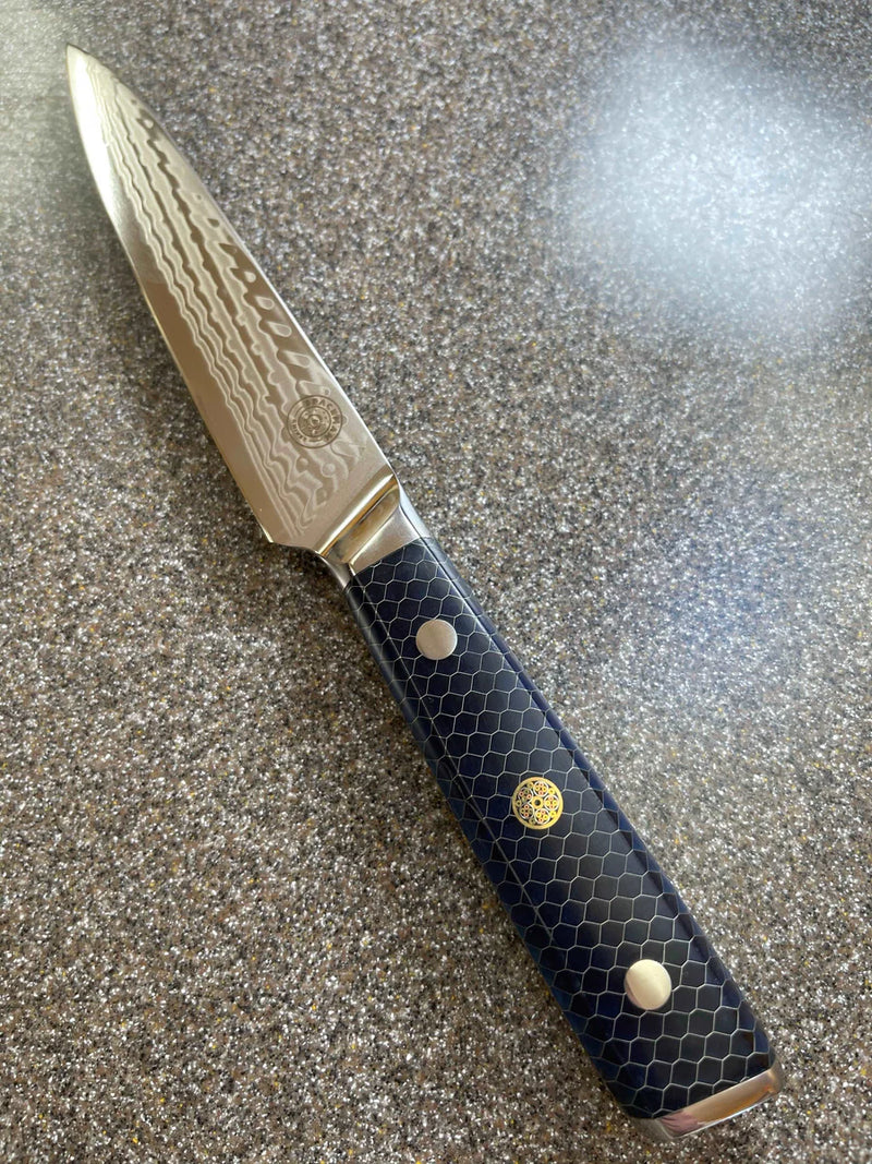 Knife with a decorative black handle on a textured surface