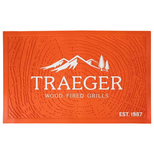 orange rubber mat with wood cookie design and white Traeger logo